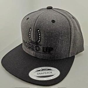 A gray and black hat with the words closed up on it.