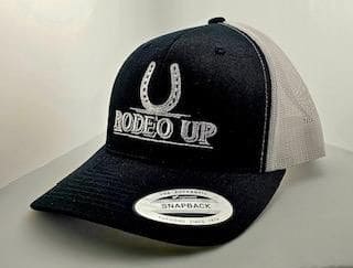 A black and white hat with the words rodeo up on it.