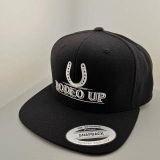 A black hat with the words rodeo up on it.